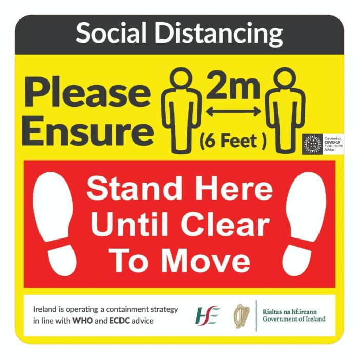 SOCIAL DISTANCING STAND HERE sign